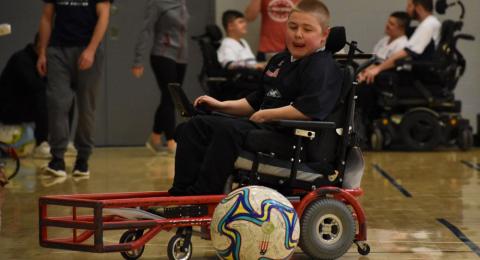 young boy participating in wheelchair court sport