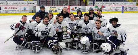 Sled Hockey team with trophy